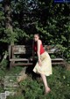 A woman sitting on a bench in a park.