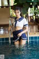 A woman in a sailor outfit standing in a pool.